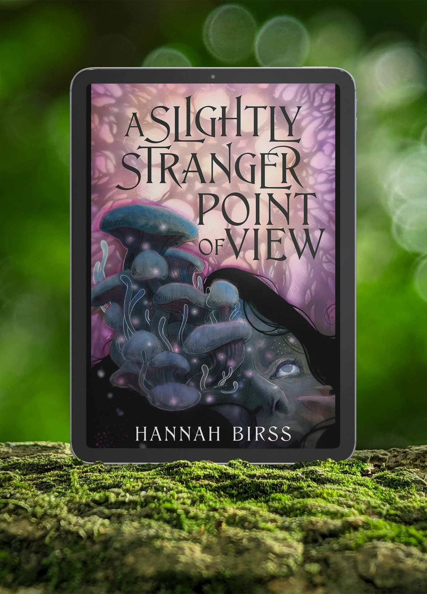 Picture of the e-book cover of A Slightly Stranger Point of View by Hannah Birss. It is displayed on a tablet sitting upright in a forest on a bed of moss.